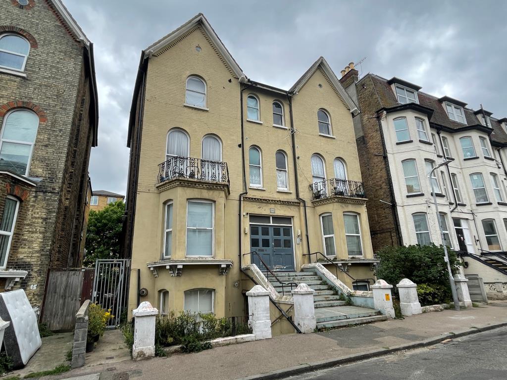 Lot: 53 - TWO-BEDROOM FLAT FOR IMPROVEMENT - External view with access to the left down alley